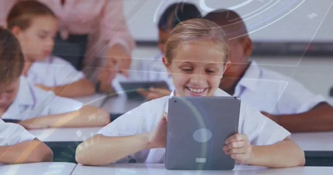 Center girl tapping tablet, completing classroom task, teacher assisting, Stock Footage 330741055