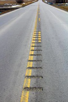 Center line rumble strips down a lonely country road Stock Photos