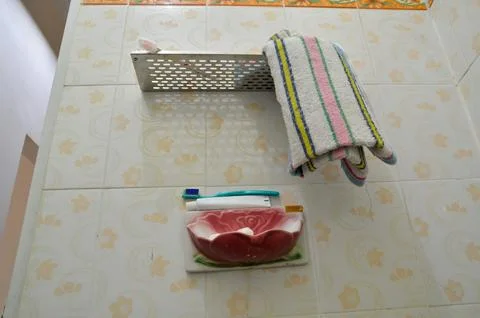 Center Low Angle Shot of Hanging Bathroom Towel and Toiletries Stock Photos