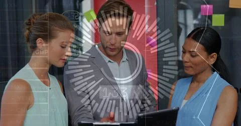 Center man tapping tablet, causing HUD updating business charts, colleagues Stock Photos