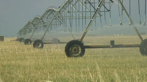 Center pivot irrigation system slowly crawls across dry field Stock Footage 144146