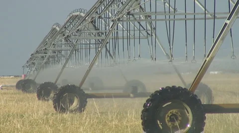 Center pivot irrigation system slowly crawls across dry field Stock Footage 2679167