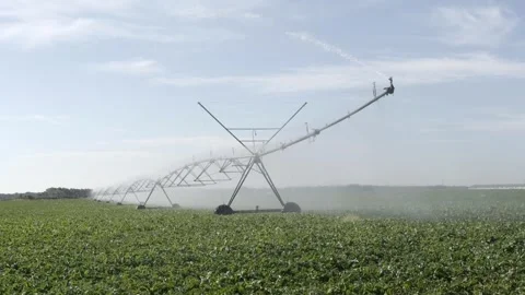 Center Pivot Irrigation System Watering Green Crop Field Under Blue Sky Stock Footage 340632943