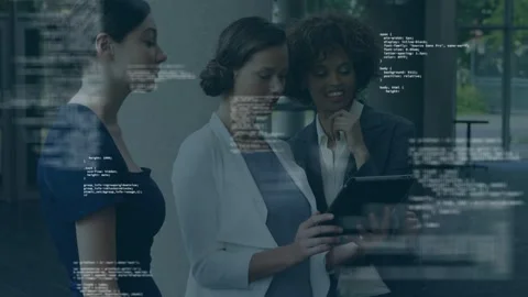 Center woman tapping tablet, causing faint code overlay, team pointing, leaning, Stock Footage 334744159