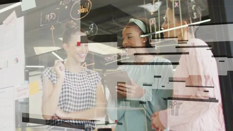 Center woman tapping tablet presenting work by glass, team reviewing tech as Stock Footage 333145250