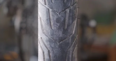 Centered bicycle wheel spins and stops showing detail of tire tread pattern. Stock Footage 139719675