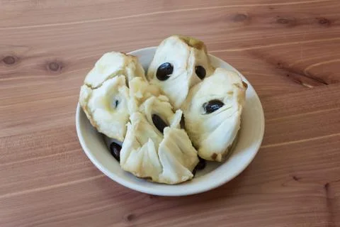 Centered dish filled with chunks of ripe Annona cherimola cherimoya fruit Stock Photos