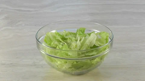 Centered salad bowl with dropping red bell peppers Stock Footage 35107468