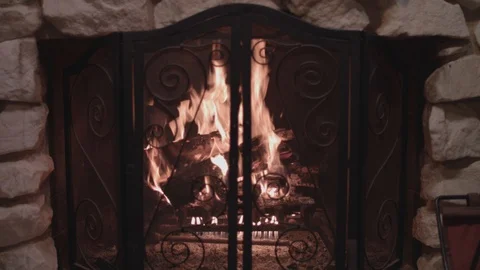 Centered shot of a bright fireplace with a large fire inside.  Stock Footage 88708778