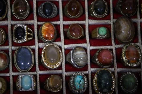 Centered shot of oval gemstone rings in grid display showing brown agates Stock Photos