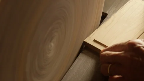 Centered shot of spinning wood surface being shaped in workshop Video stock 104220686