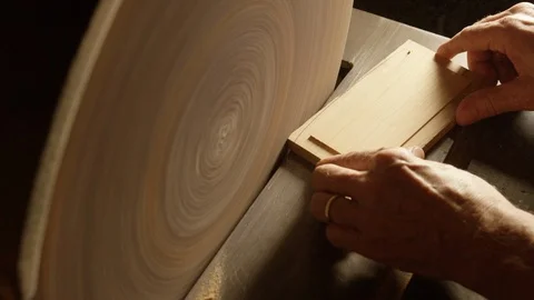 Centered shot of spinning wood surface being shaped in workshop Stock Footage 104220790