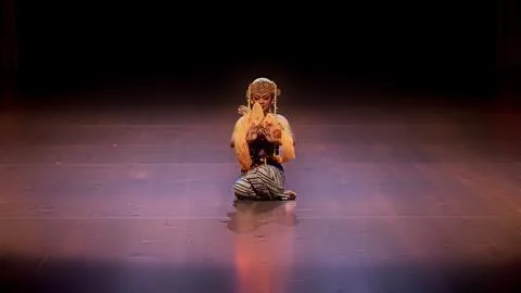 Centered Solo Dancer Performing Prayer Gesture Under Spotlight Stock Photos