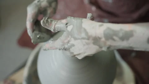 Centered wheel with wet clay texture focus. Ceramic artist centering on wheel in Stock Footage 337363378