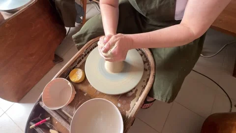 Centering clay on a potter's wheel. Human's hands. Potter at work Stock Footage 277789634