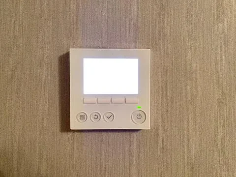 Central air conditioning control on the wall close-up with mockup Stock Photos