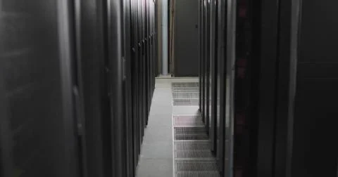 Central aisle running between server racks in data center hallway with tiles  Stock Photos