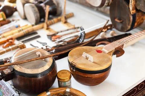 Central Asian stringed musical instruments are put up for sale at a bazaar Stock Photos