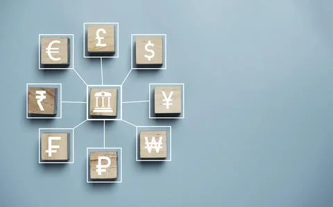 Central banking and multi currency icons print screen on wooden cube block .. Stock Photos