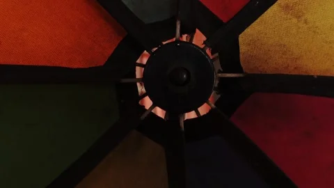 A central dark circular object surrounded by blurred colorful elements Stock Footage 346862202