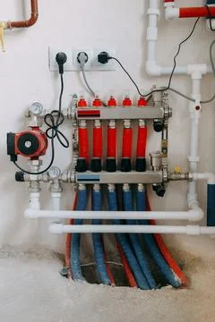 Central heating system image showing multiple red and blue pipes connected to Stock Photos