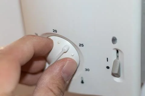 Central Heating thermostat control dial adjustment Stock Photos