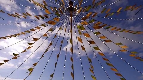 Central hub canopy lifting in gusting wind, pennants fluttering, creating yellow Stock Footage 340674624