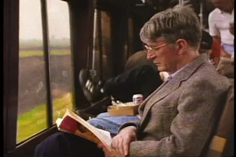 CENTRAL ILLINOIS, 1994, Middle age man reads book on California Zephyr Stock Footage 10918228