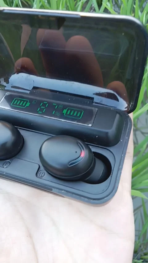 Central Java Indonesia 10 June 2024: someone holding tws, gadget theme. Stock Footage 277650856