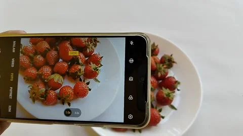 Central Java Indonesia 13 May 2026: A smartphone camera capturing fresh strawber Stock Footage 336289382