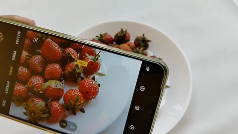 Central Java Indonesia 13 May 2026: A smartphone camera capturing fresh strawber Stock Footage 336289383