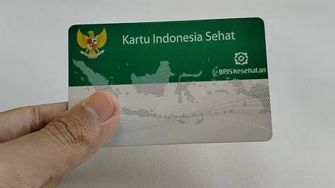 Central Java Indonesia 16 July 2026: Hand holding an Indonesian Health Card with Stock Footage 340120183