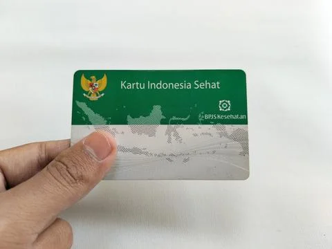 Central Java Indonesia 16 July 2026: Hand holding an Indonesian Health Card with Stock-Fotos