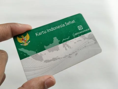 Central Java Indonesia 16 July 2026: Hand holding an Indonesian Health Card with Stock-Fotos