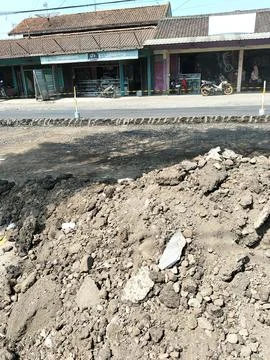 Central Java Indonesia 16 July 2026: Road construction site with piles of excava 스톡 사진