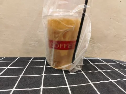 Central Java Indonesia 18 February 2026: Popular iced tea in a takeaway cup Fotos de archivo