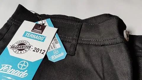 Central Java Indonesia 2 March 2026: New black pants with brand label attached Video stock 330807993