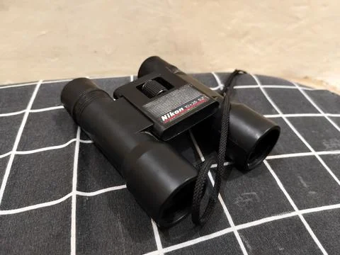 Central Java Indonesia 22 may 2026: Binoculars on a bed in a close-up view Stock Photos