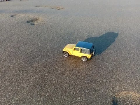 Central Java Indonesia 26 June 2024: toy car on the beach sand, holiday concept  Stock Photos