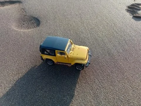 Central Java Indonesia 26 June 2024: toy car on the beach sand, holiday concept  Stock Photos