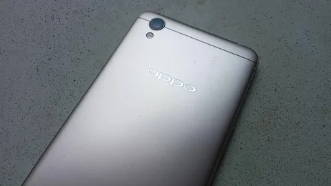 Central Java Indonesia 27 October 2024: Rear Oppo brand smartphone. Stock Footage 289741363