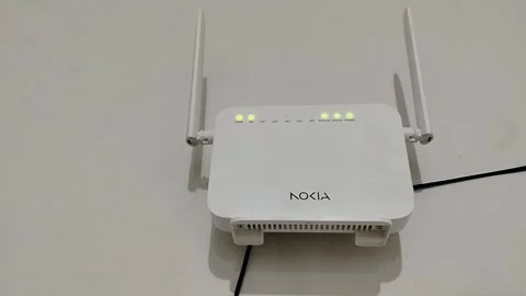 Central Java Indonesia 28 March 2026: Nokia WiFi router mounted on wall, active  Video stock 332625816