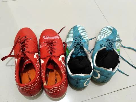 Central Java Indonesia 28 March 2026: Two pairs of worn football cleats placed s Stock-Fotos