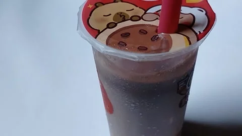 Central Java Indonesia 3 april 2026: Cup Momoyo drinks in a small beverage  Stock Footage 332159473