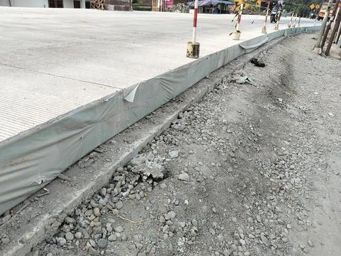 Central Java Indonesia 4 July 2026: Newly completed concrete road with roadside  Stock Photos