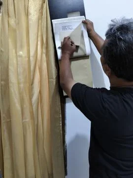 Central Java Indonesia 5 August 2026: A male interior designer comparing fabric  Stock-Fotos
