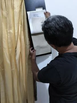 Central Java Indonesia 5 August 2026: A male interior designer comparing fabric  Stock-Fotos