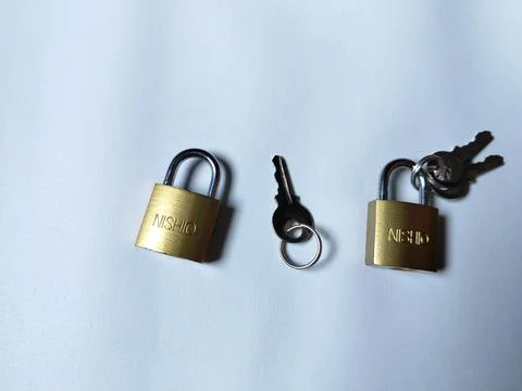 Central Java Indonesia 5 may 2026: Metal padlock key isolated on plain backgroun 写真素材