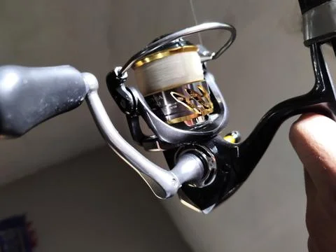 Central Java Indonesia 7 February 2026: Fishing reel detail with metallic  Stock Photos