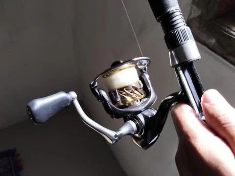 Central Java Indonesia 7 February 2026: Fishing reel detail with metallic  Stock-Fotos